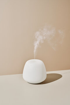 Modern essential oil diffuser on table