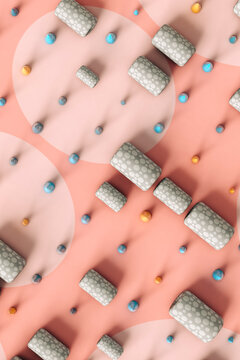 top view of Abstract cones and tubes on a pink a-pois background