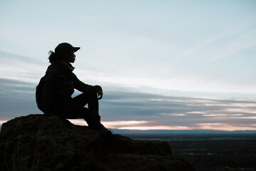 Woman Sitting on Mountaintop