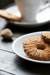 Butter cookie and a cup of Coffee  on rustic wooden background. Close up.