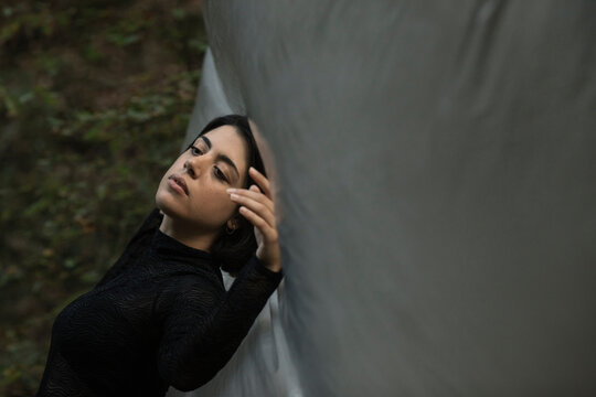 Young Woman Dancing In The Forest With A Plastic Sheet