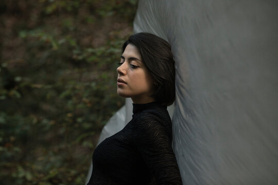 Young Woman Dancing In The Forest With A Plastic Sheet