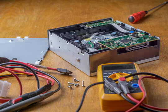 Repair Of A DVD Player. Multimeter, Screwdriver And Cables