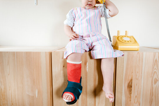 Close up of a toddler with a cast