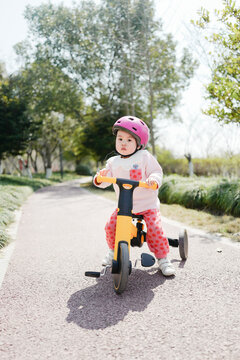 Asian baby riding tricycle