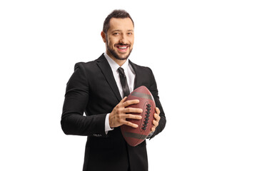 Young man in a suit and tie holding a rugby ball