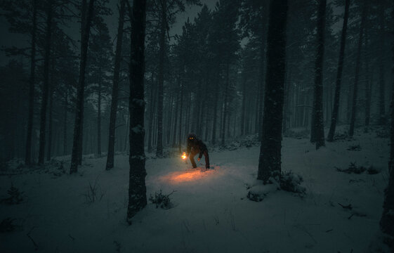 Creepy man on the snow with a torch