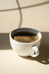 Cup of coffee on beige studio background