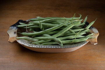 green beans in a fountain on wooden table