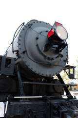 Fototapeta na wymiar Low angle front shot of steam railway locomotive showing the headlamp and smoke box