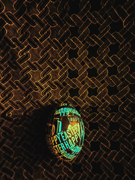 Happy Easter egg on a dark intricate fabric pattern background 