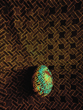 Rainbow DIY Easter egg on a dark pattern background