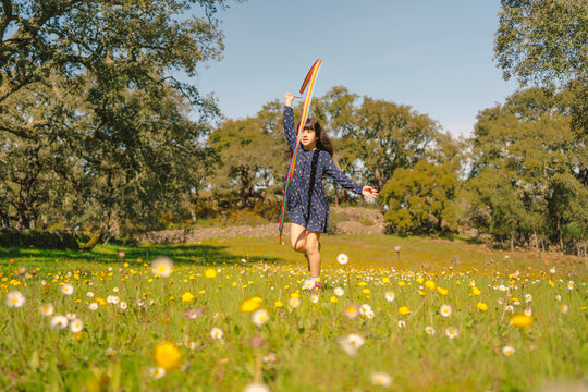 Little girl enjoying with her rhythmic gymnastics ribbon in spring