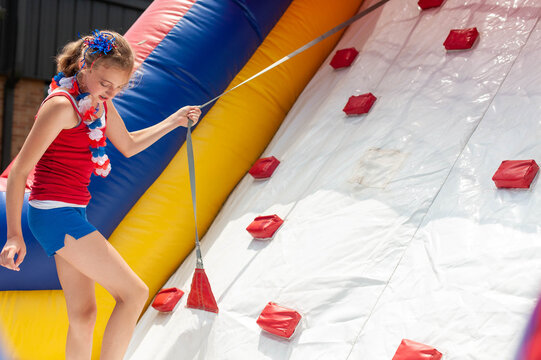 Girl playing on an inflatable climbing wall.