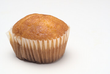 muffin in paper mold isolated on white background
