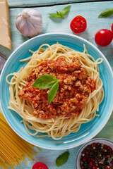 spaghetti bolognese on a wooden surface