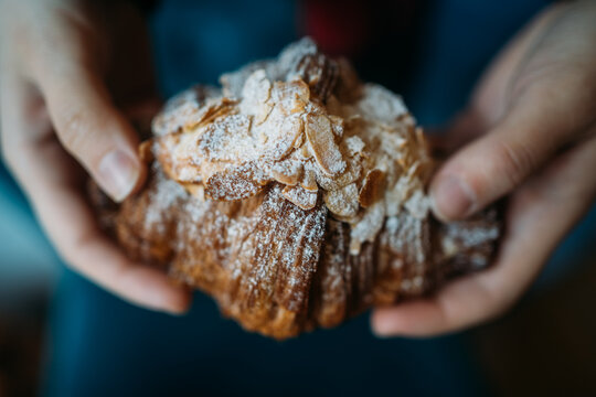 Crop person holding croissant