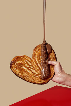 chocolate paste falling on a heart-shaped pastry