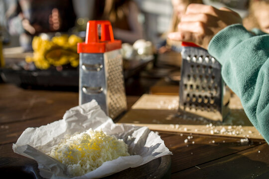Teenage girl grating cheese for lunch