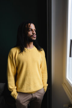 Portrait of man looking out the window