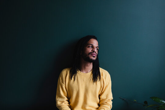 Portrait of man leaning against the wall