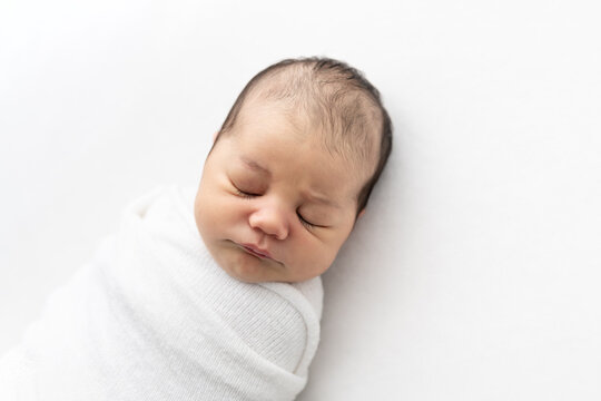 Swaddled Newborn on White