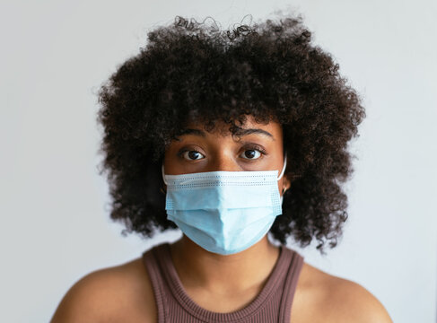 African American lady with face mask looking at camera