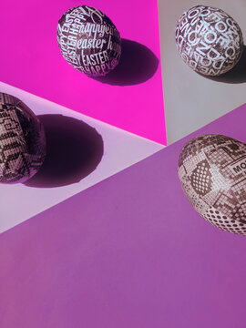 DIY handmade typographic Easter eggs arranged on a retro pastel colorful paper