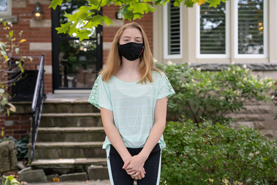 Teenage Girl Wearing Mask on First Day Back to School During Pandemic Shutdown
