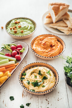 Food: different styles of hummus and vegetables