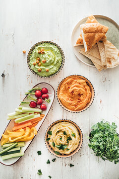 Food: different styles of hummus and vegetables