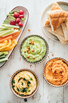Food: different styles of hummus and vegetables