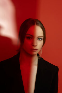 Portrait of a young blond girl in a suit 