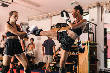 Thai Female Muay Thai Athlete Kicking The Opponent