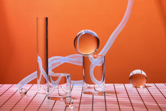 Geometric shapes - ball, cube, cylinder, prism on a light paper background. Bright composition. Interesting concept.