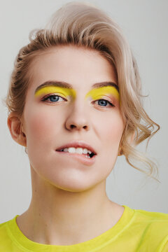 Cute woman with neon yellow make up 