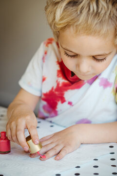 Toddler Boy Putting On Pink Nailpolish