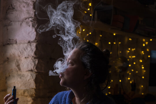 woman enjoying smoke. 