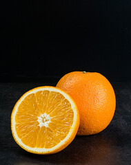 orange fruit on the table with black background
