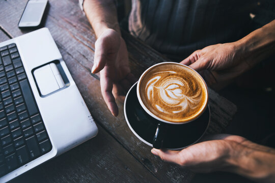 Cafe: Man Takes Break From Computer Work For Coffee