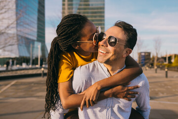 Black woman giving piggyback ride to man
