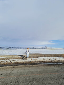 Woman in sportswear runing on a snowy field