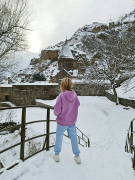 
Woman with near the church in the mountains