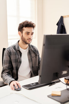 Young guy browsing data on computer