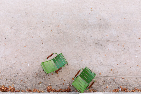 A pair of Paris green garden chairs in the dirt