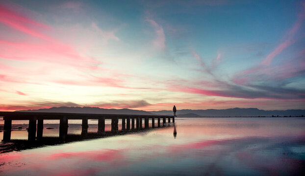 Distant human silhouette standing at the dock