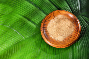 Lepidium meyenii - Peruvian maca powder in the wooden bowl