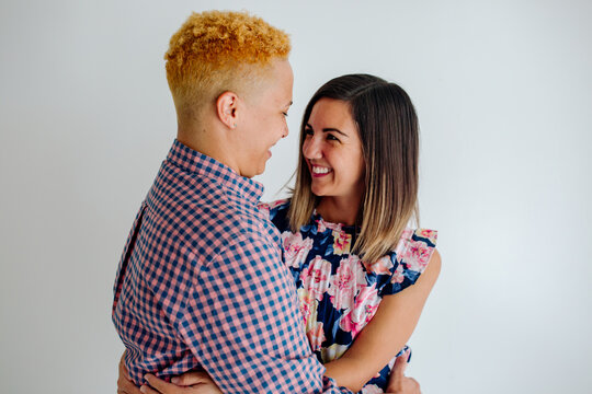 Happy female partners embracing - Powered by Adobe