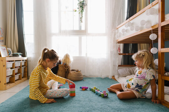 Two girls playing together in a room