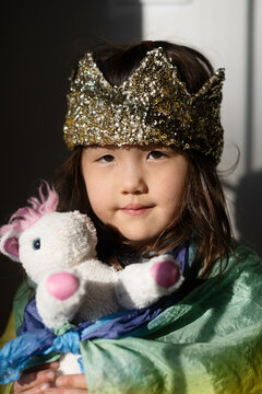 Little girl with unicorn stuffed animal